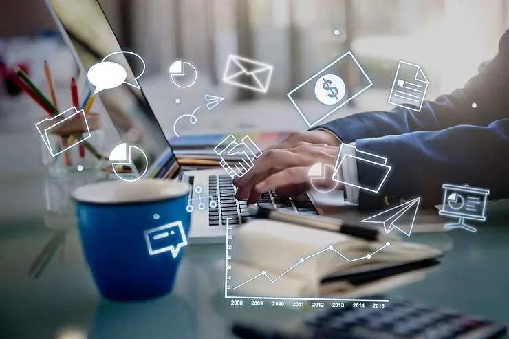 Laptop and coffee mug with digital marketing icons and charts