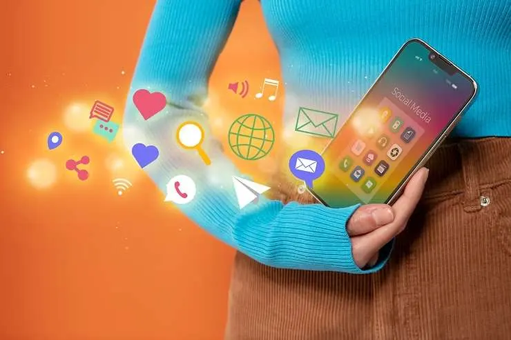 Hand holding a smartphone with colorful app and search icons