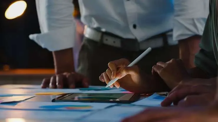 Team reviewing charts and documents on a desk