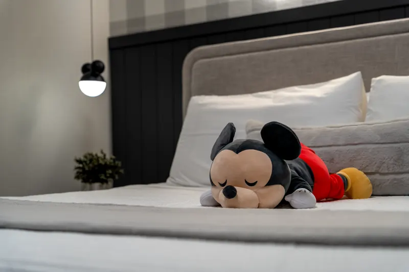 Themed bedroom detail with a plush toy on the bed