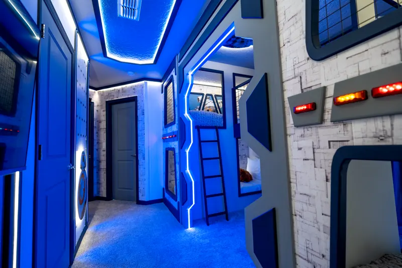 Space-themed bunk room with blue LED lighting