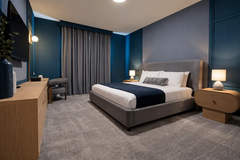 Navy suite with king bed, desk and TV